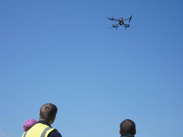 Portsmouth Water Employees watching drone rise into sky