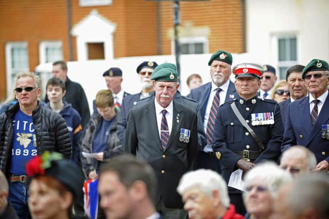 Veterans, including Stewart Bratherton, second-right, watch on as a flag is raised at The Falklands Memorial in Old Portsmouth to mark the 37th anniversary of the end of the Falklands War in 2019. Picture: Ian Hargreaves  (140619-5)