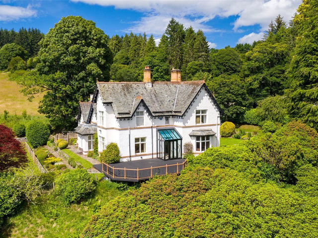 The house has original features such as fine cornicing, panelled doors, part-leaded windows, decorative fireplaces and carved wooden staircase,