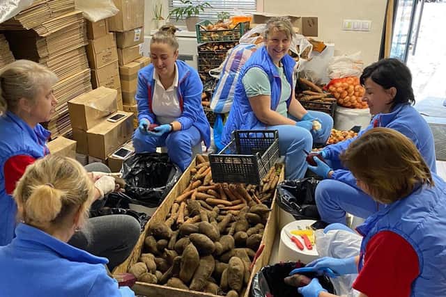Undated handout photo issued by Bridge to Unity of a ladies peeling vegetables in Eksulab in Ukraine