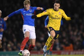 Ross McCrorie fends off Arsenal's Gabriel Martinelli in Pompey colours. (Photo by Stuart MacFarlane/Arsenal FC via Getty Images)