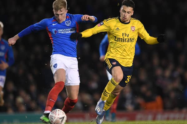 Ross McCrorie fends off Arsenal's Gabriel Martinelli in Pompey colours. (Photo by Stuart MacFarlane/Arsenal FC via Getty Images)