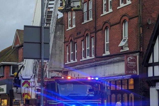 Firefighters fixing loose roof tiles and a sign above Poppins Cafe in North Street, Havant, on January 2.