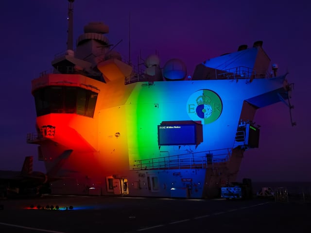 HMS Queen Elizabeth lights up her aft island in celebration of PRIDE and the LGBTQ+ Community.