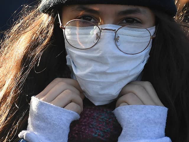 A woman wears a protective face mask. Picture: DANIEL LEAL-OLIVAS/AFP via Getty Images