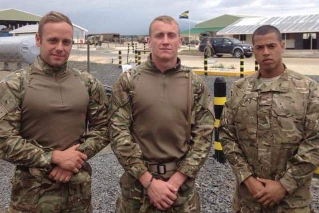 Daryl Green, 27, of Cosham, pictured centre, during a deployment in Kenya in 2013. On Wednesday, he will be taking on a 24-hour rowing event for charity.