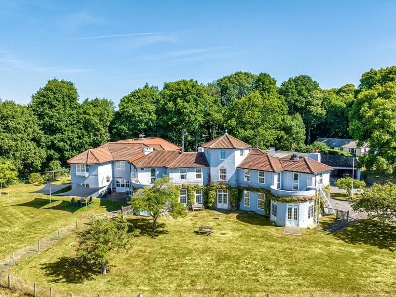 The listing says: "The estate was purchased by the Carter family in 1960 with the intention of developing the apple farm and creating an equestrian facility on the estate. The principal building, High Hurlands, was built in 1933, designed by William Curtis Green around a hexagonal hall and 2 wings to maximise the uninterrupted views"