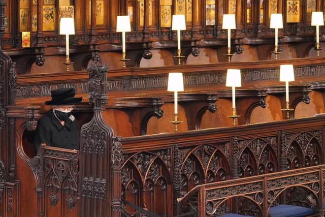 The Queen sits alone at the funeral of Prince Philip in St George's Chapel at Windsor Castle on April 17, 2021. Photo by Jonathan Brady - WPA Pool/Getty Images