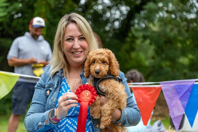 12 week old cockapoo, Rosie, won the cutest puppy competition at the Denmead Fun Dog Show. Her owner Jacqui Humphreys proudly shows off the award.Picture: Mike Cooter (210724)