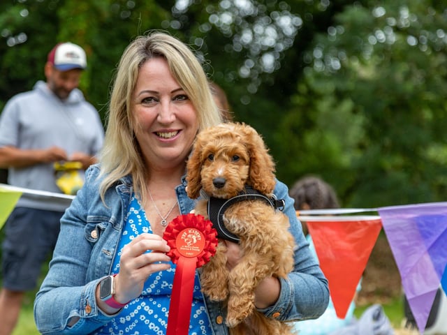 12 week old cockapoo, Rosie, won the cutest puppy competition at the Denmead Fun Dog Show. Her owner Jacqui Humphreys proudly shows off the award.Picture: Mike Cooter (210724)