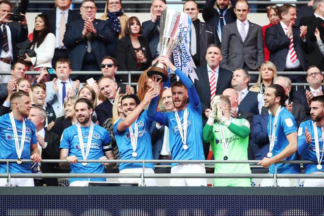 Tom Naylor holds the trophy aloft at Wembley
