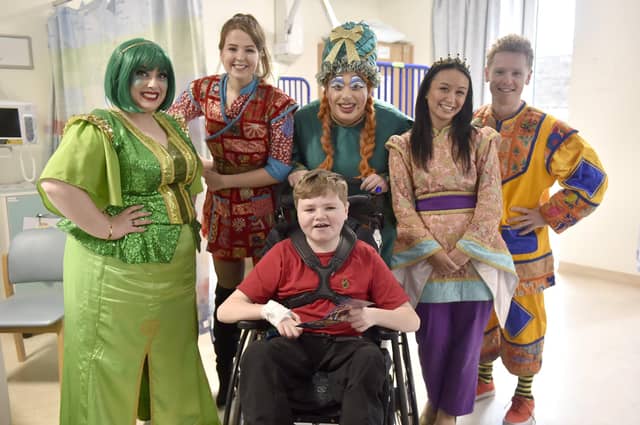 Pictured is: Cast (l-r) Shani Cantor as Genie of the ring, Emma Marsh as Aladdin, Chris Aukett as Widow Twankey, Kaysha Nada as Princess Jasmine and James Oates as Wishee-Washee with Trevor Williams (16).