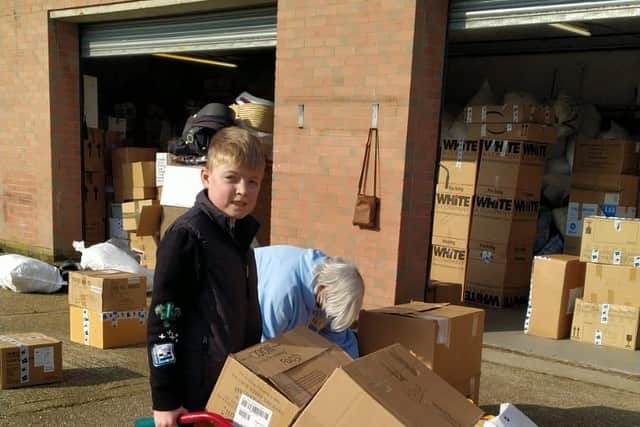 Jacobs Well Care Centre in Toronto Place, Gosport, is taking donations for food, medicine, clothes, and other essentials. Pictured is: Rogan Morrill (12) with some of the food donations.