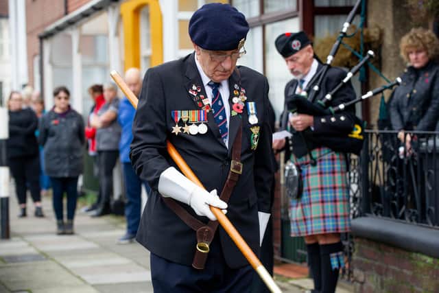 Clive Sutton lowers the standard during the two-minute silence.
Picture: Habibur Rahman