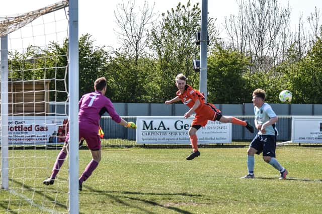 Harvey Aston (orange) in action for AFC Portchester in their Hampshire Invitational Cup win over Petersfield Town. Pic: Daniel Haswell.