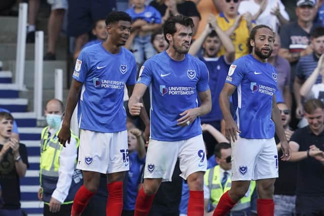 John Marquis, centre, celebrates his opener in Pompey's 2-0 win against Crewe on Saturday. Picture: Jason Brown