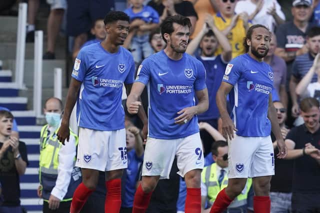 John Marquis, centre, celebrates his opener in Pompey's 2-0 win against Crewe on Saturday.  Picture: Jason Brown