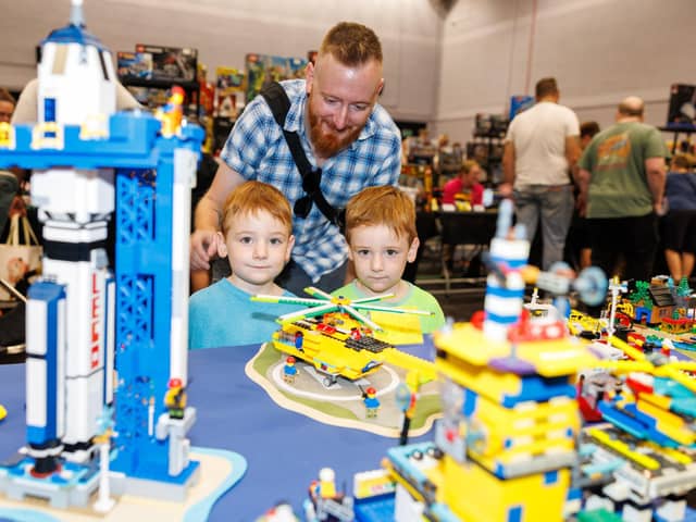 Jack and Max, with their dad Chris, planning their next Lego project.  Picture: Marcin Jedrysiak