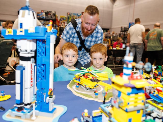 Jack and Max, with their dad Chris, planning their next Lego project.  Picture: Marcin Jedrysiak