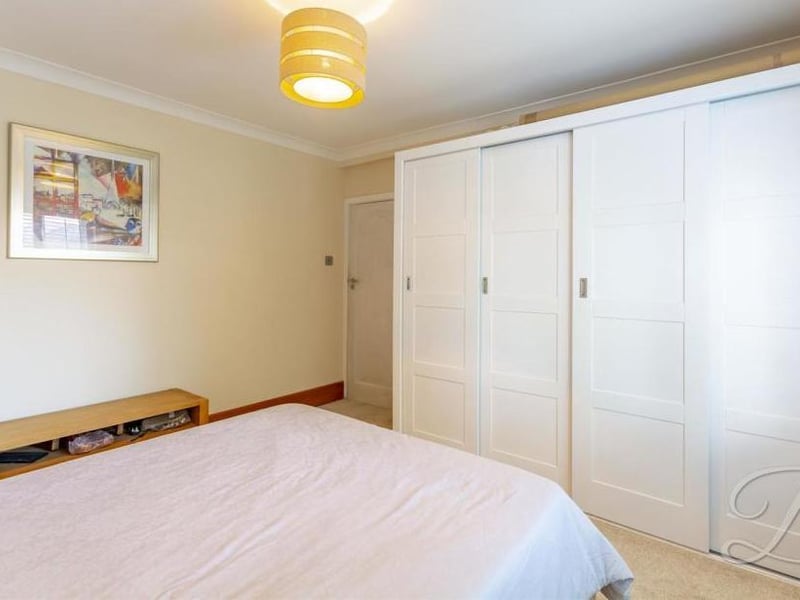 Modern, fitted wardrobes are a feature of the second bedroom at the Nottingham Road property. It also has a carpeted floor, radiator and window at the back.