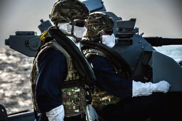 Sailors on HMS Chiddingfold preparing to operate the 30mm Mark 44 Bushmaster gun during live fire training.