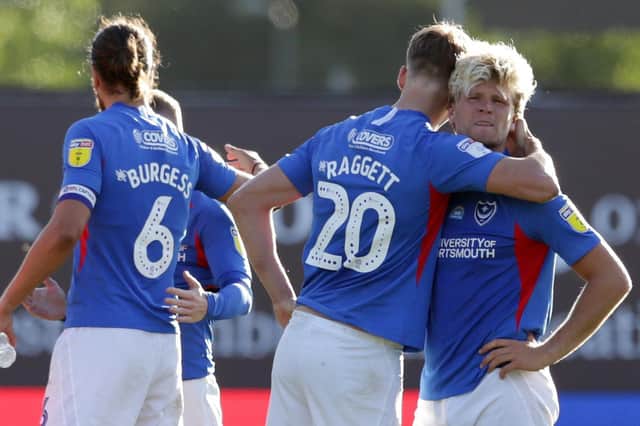 Sean Raggett consoles team-mate Cameron McGeehan after Pompey's play-off defeat against Oxford Picture: Robin Jones/Getty Images