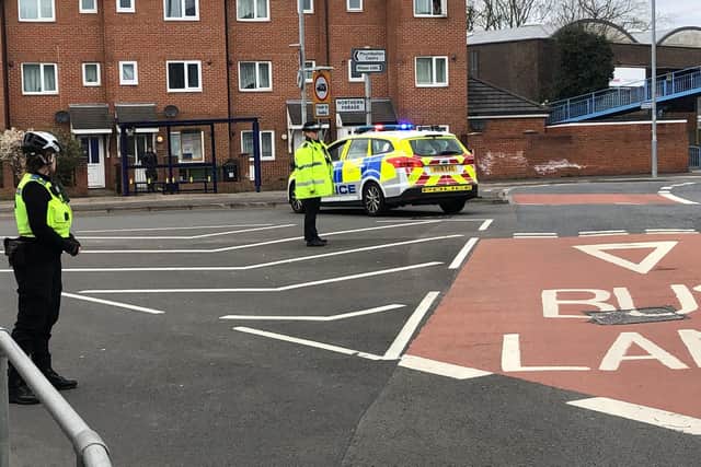 A car crashed in Northern Parade, Hilsea, leaving one person with chest injuries. Pictured: Officers manning a road block. Photo: Tom Cotterill