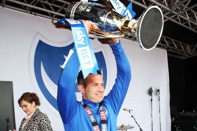 Michael Doyle holds aloft the League Two trophy in front of supporters at Southsea Common. Picture: Joe Pepler