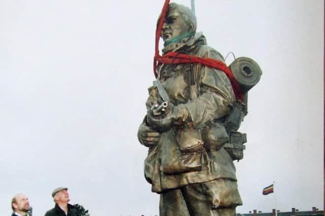 The Yomper statue being put up at the entrance to the Royal Marines Museum,  Eastney. It is being inspected by sculptor Philip Jackson (left) and museum director Colonel Keith Wilkins, July 5, 1992.
