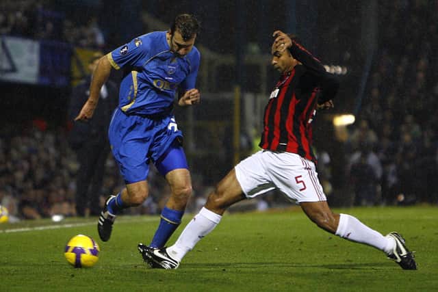 Pompey winger Glen Little and AC Milan's Emerson battle for the ball. Picture: Chris Ison