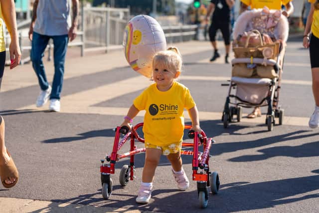 Esme Groves (2) sets off for her charity walk from South Parade Pier to raise money for charity Shine.