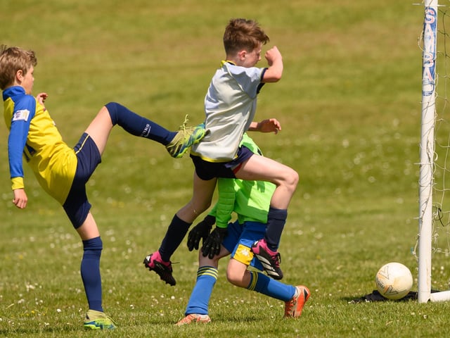 Action from the Clanfield youth football tournament at Horndean Technology College. Picture: Keith Woodland (270521-433)