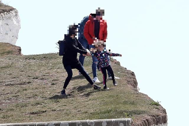 The child is pulled away to safety. Picture: Gareth Fuller/PA Wire