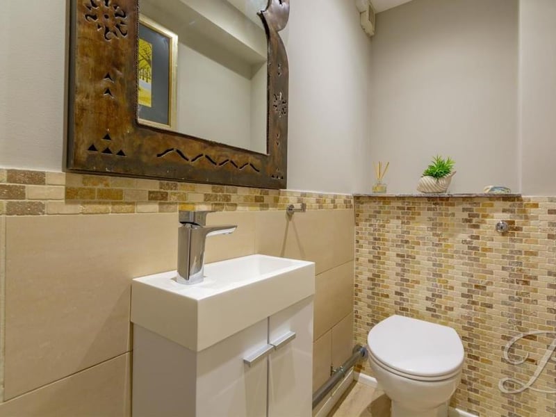 Even the toilet has a touch of class about it. A low-flush WC is complemented by a pedestal wash basin.