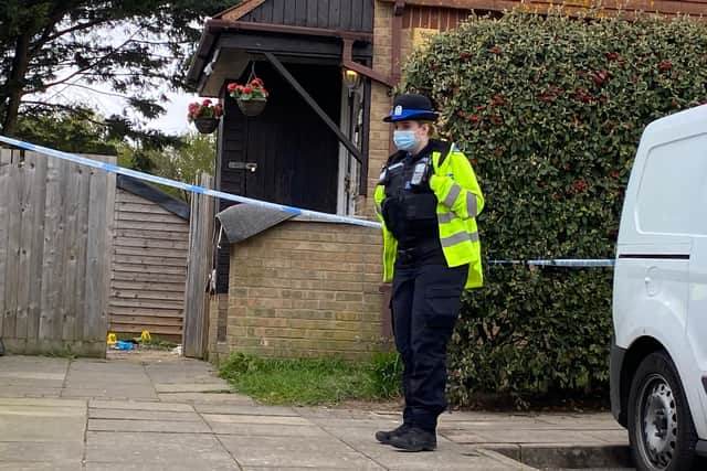 An officer stands guard outside a property in Tunstall Road, Paulsgrove, where a man was found seriously injured in a garden. Photo: Tom Cotterill