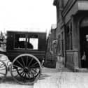 Not the Wild West but perhaps Wild East. A bank teller loads cash from the bank on the corner of Glasgow Road, Eastney.
