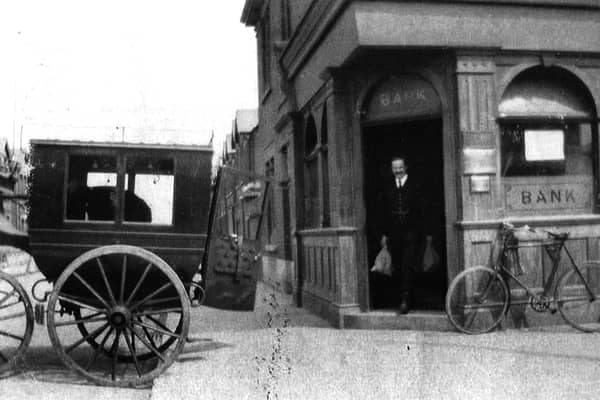 Not the Wild West but perhaps Wild East. A bank teller loads cash from the bank on the corner of Glasgow Road, Eastney.