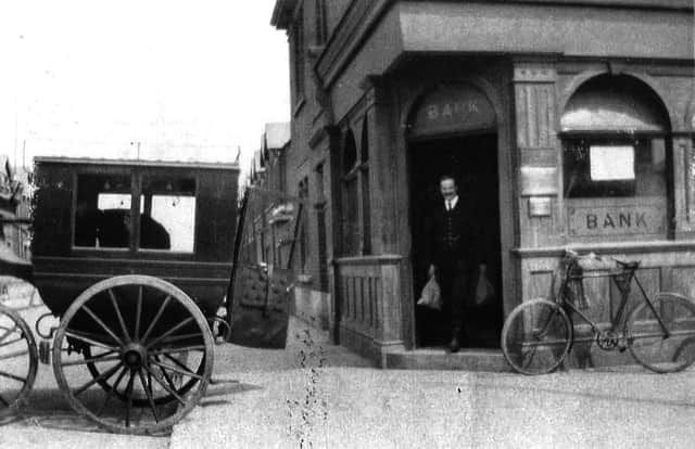 Not the Wild West but perhaps Wild East. A bank teller loads cash from the bank on the corner of Glasgow Road, Eastney.