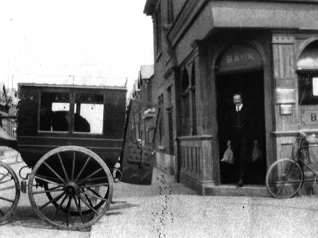 Not the Wild West but perhaps Wild East. A bank teller loads cash from the bank on the corner of Glasgow Road, Eastney.