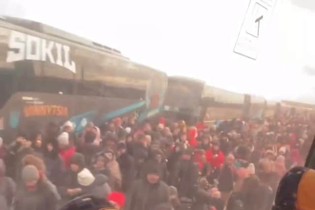 Thousands of people fleeing Ukraine are pictured queuing for buses heading out of the country.