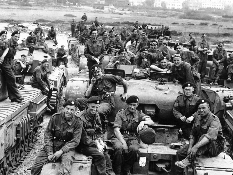 Crewmen from British Churchill tanks, waiting at (probably) Stokes Bay to load onto (probably) an LST that will take them to Normandy.