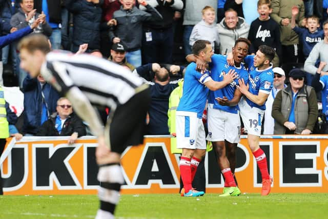 Jamal Lowe celebrates with Michael Doyle and Conor Chaplin after netting his second goal against Notts County as Pompey win promotion at Meadow Lane in April 2017. Picture: Joe Pepler