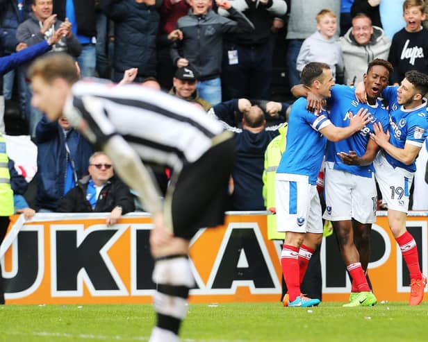 Jamal Lowe celebrates with Michael Doyle and Conor Chaplin after netting his second goal against Notts County as Pompey win promotion at Meadow Lane in April 2017. Picture: Joe Pepler