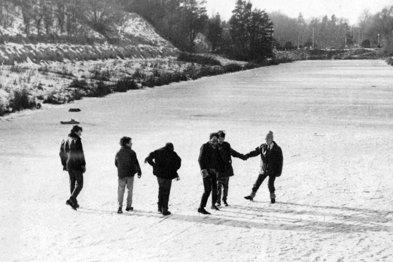 A group of people walking on the moat at Hilsea, Portsmouth, at Christmas 1962
