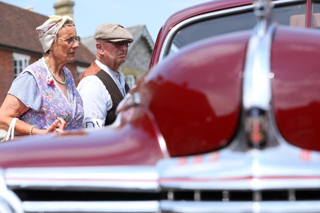 Re-enactors Elaine Sparrow and Terry Lemmon admire a 1942 Dodge.