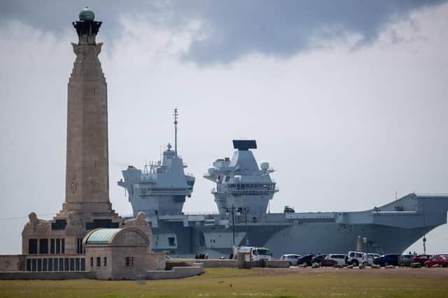 The Royal Navy aircraft carrier HMS Prince of Wales passes the Portsmouth Naval Memorial as it returns to Portsmouth Harbour after taking part in sea trials. Picture date: Wednesday May 26, 2021. PA Photo. See PA story War, Conflict and Military Carrier . Photo credit should read: Andrew Matthews/PA Wire 