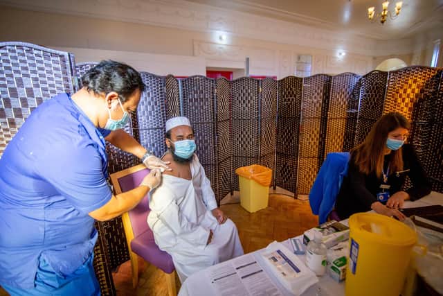 Dr Ebadur Chowdhury giving the vaccine to one of the imaans, MD Golem Rahman with Miranda Smith taking his details.Picture: Habibur Rahman
Picture: Habibur Rahman
