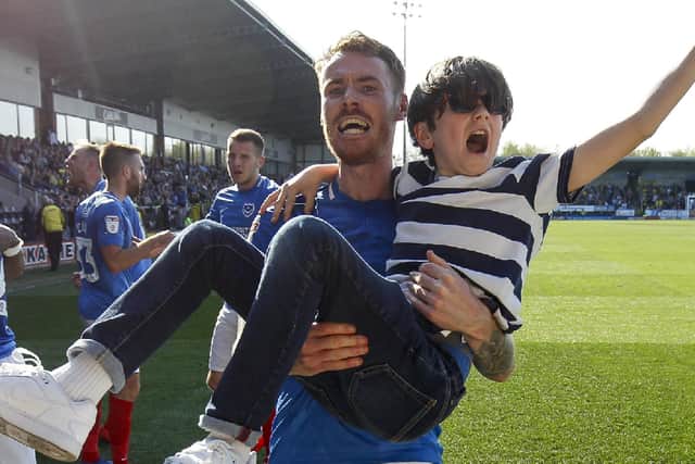 Tom Naylor carries a young fan after Pompey net a late winner at Burton in April 2019. Picture: Daniel Chesterton/phcimages.com/PinPep