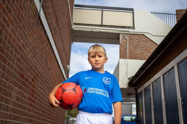Reggie Mears, eight, standing below the walkway where he was struck by a brick thrown by another child.
Picture: Alex Shute
