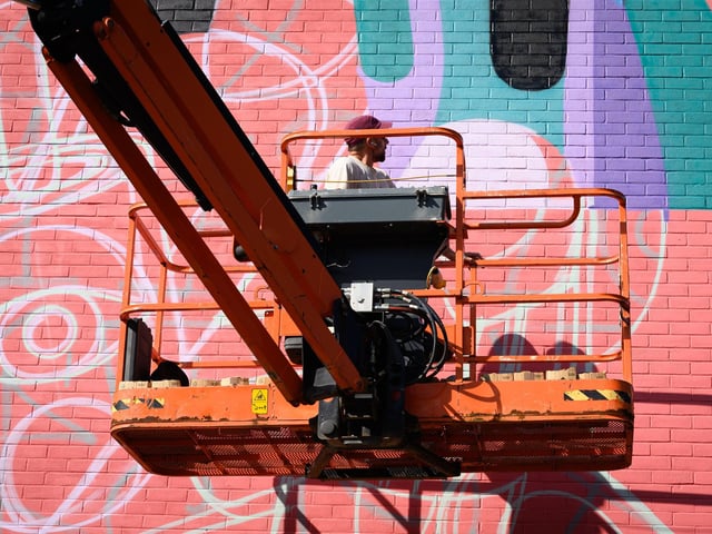 Pictured is: Reka One at work on his creation on the side of 23 St Pauls Road
Picture: Keith Woodland (140921-69)